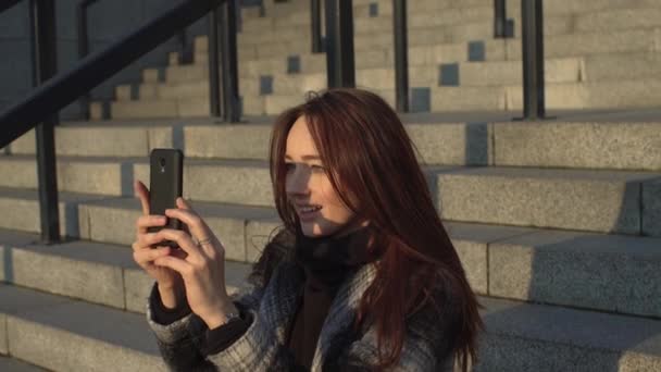 Girl Sitting on the Steps With a Telephone - Footage, Video