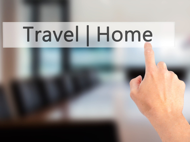 Travel  Home - Hand pressing a button on blurred background conc - Фото, зображення