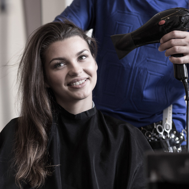 Hairstylist drying woman's hair - Photo, Image