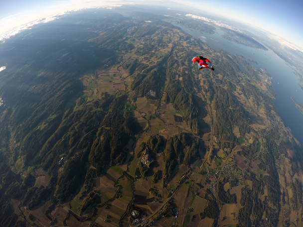 Wingsuit skydiving over clouds - Photo, Image