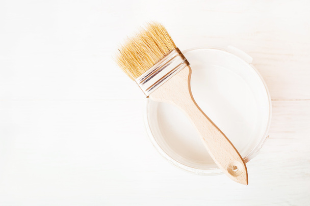 Bank paints and brush on a wooden background - Foto, Bild