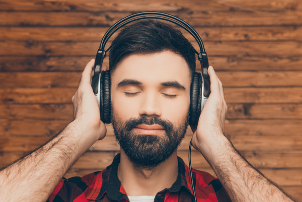 Close up portrait of relaxed man in head-phones listening music  - Photo, Image