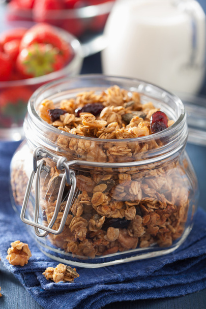 homemade healthy granola in glass jar and berries - Photo, image