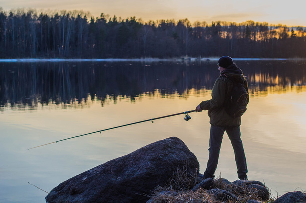Fisherman at sunset fishing - Foto, immagini