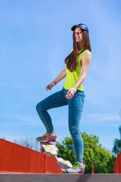 Teen girl skater riding skateboard on street. - Fotó, kép