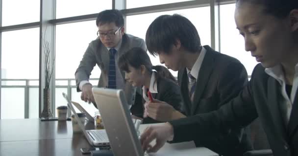 Japanese start up Business team work on a project together motivated moving shot  - Кадры, видео