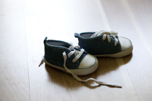 A pair of blue shoes on wooden surface - Fotografie, Obrázek