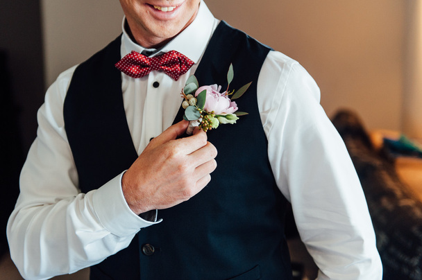 Groom tying tie on a white shirt - Фото, изображение