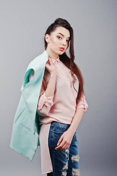 Portrait of young brunette girl wearing in pink blouse, turquois - Foto, afbeelding