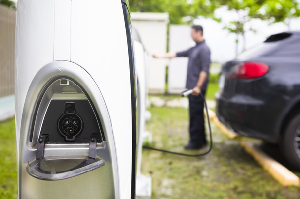 man operating Power supply station for electric car charging - Photo, Image
