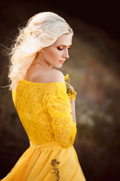 beautiful lady in a long yellow dress - Фото, зображення