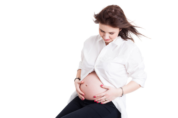 Portrait of loving pregnant woman caressing her belly - Photo, Image