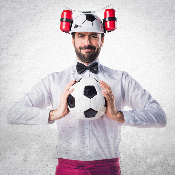 Crazy waiter holding a soccer ball - Photo, Image