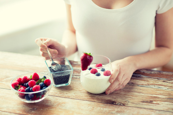 close up of woman hands with yogurt and berries - Foto, immagini