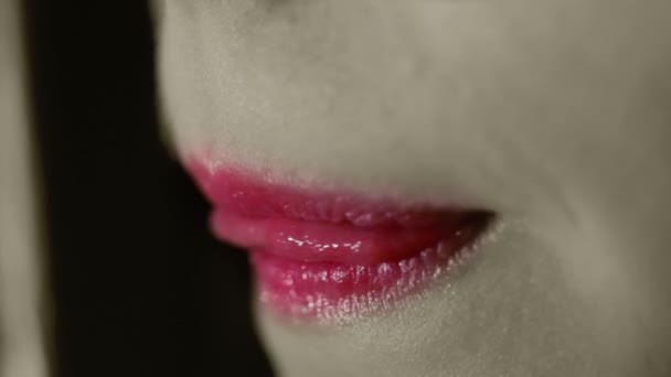 Red lips. Black and white concept. Woman mouth bites lip. Sexy female lips close up - Video