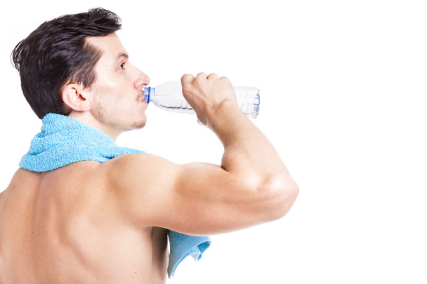 Fitness man drinking a bottle of water - Fotó, kép