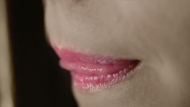 Pink lips of young woman. Pink lipstick on fashion model lips. Sensual woman mouth - Záběry, video