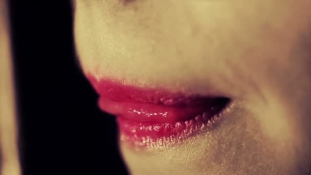 Lips close up. Sexual woman bites lip. Sexual girl mouth closeup - Felvétel, videó
