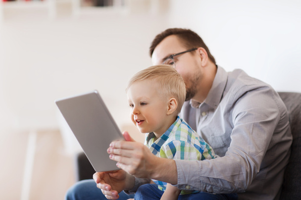 father and son with tablet pc playing at home - Photo, Image