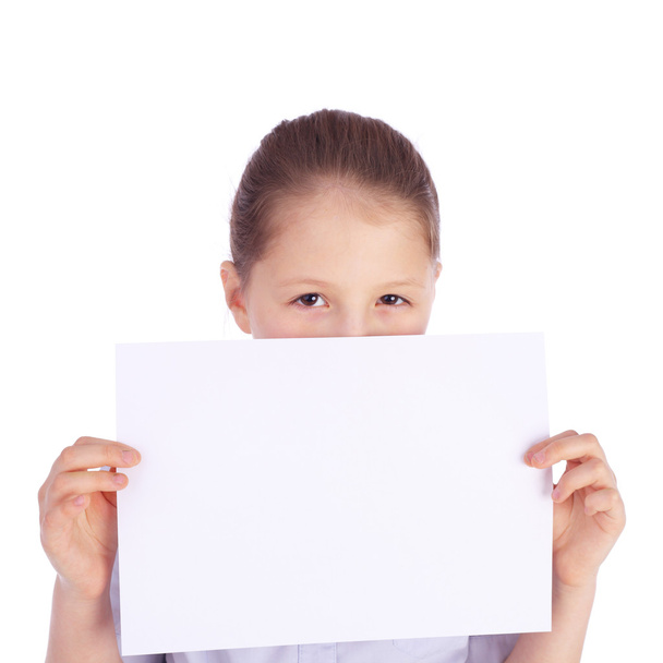 pretty little school girl holding blank sheet of paper - Foto, imagen