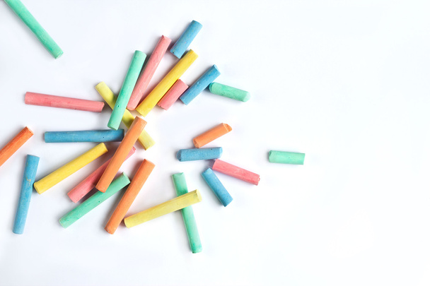 colorful chalks scattered on a white background - Photo, Image