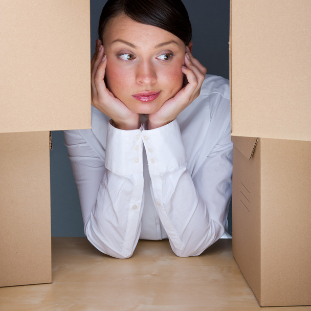 Portrait of young woman surrounded by lots of boxes. Lots of wor - Φωτογραφία, εικόνα