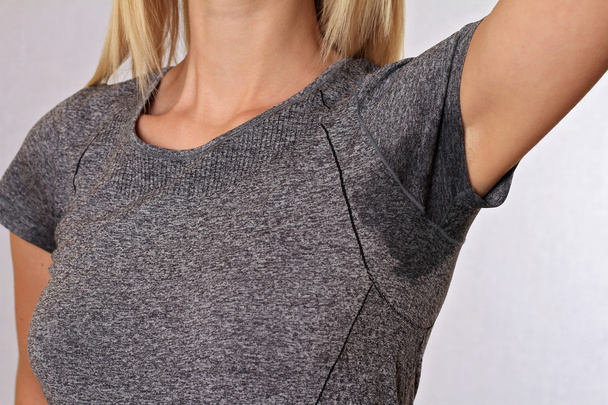 Sport woman armpit sweating. Transpiration stain. Hyperthyroidism concept - Φωτογραφία, εικόνα
