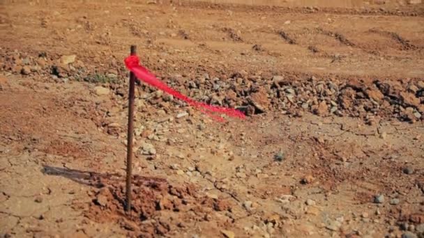 Metal survey peg with red flag on construction site - Footage, Video