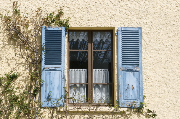 Beige wall with blue shutters window - Fotoğraf, Görsel