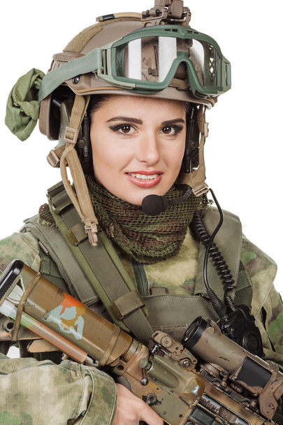beautiful young girl soldier with weapon posing against white background  - Фото, изображение