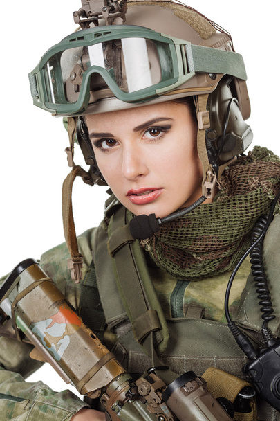 beautiful young girl soldier with weapon posing against white background  - 写真・画像