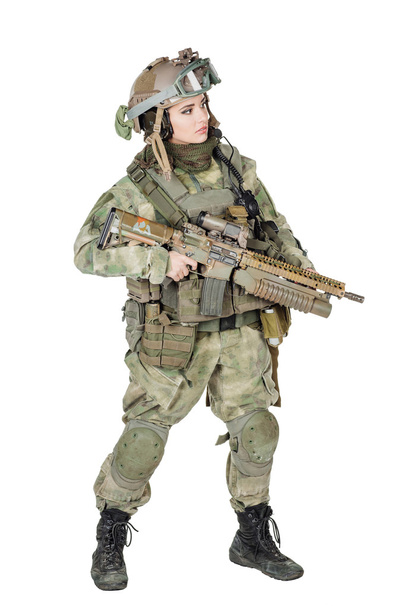 beautiful young girl soldier with weapon posing against white background  - Photo, image