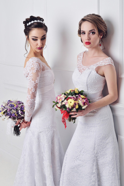 Two beautiful bride posing together - Foto, imagen