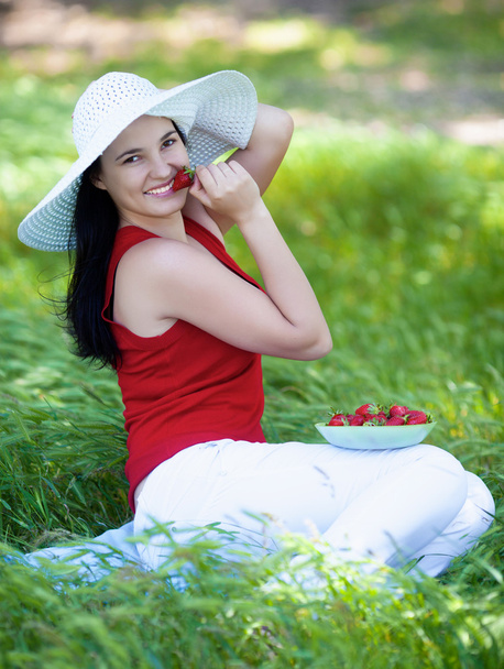 Girl with straberry in garden - Photo, image