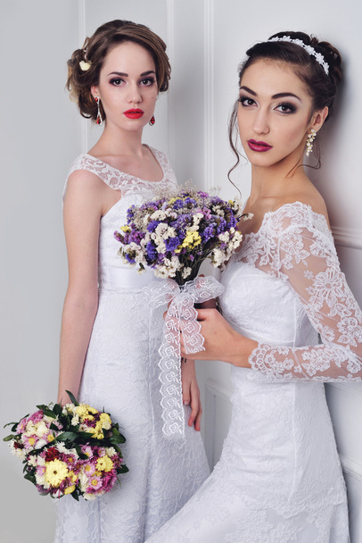 Two beautiful bride posing together - Fotó, kép
