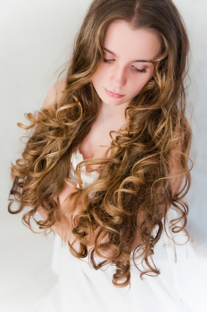Young girl with beautiful curls - 写真・画像