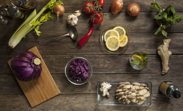 red cabbage, tomatoes, garlic and onions on old wooden table - Foto, afbeelding