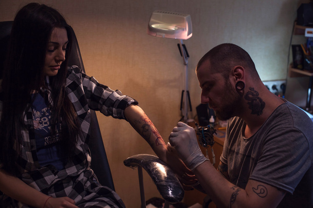Tattooer makes tattoo for woman - Photo, Image
