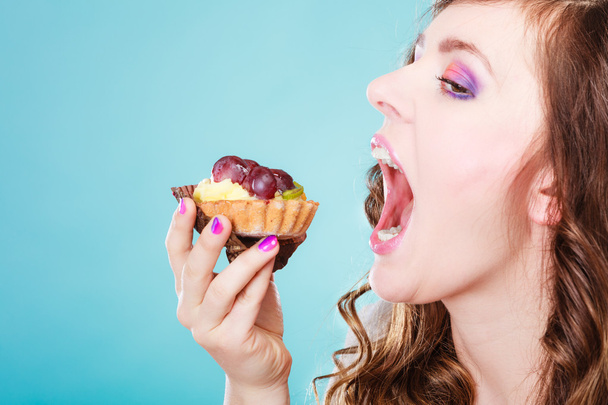 woman face profile open mouth eating cake - Photo, image