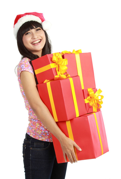 Christmas woman holding gifts wearing Santa hat - Photo, Image