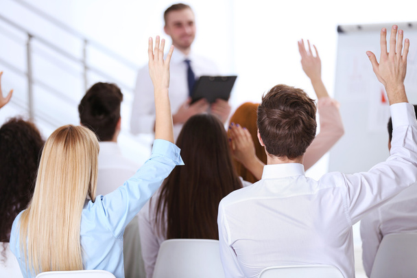 colleagues raising hands at the business meeting - Фото, зображення