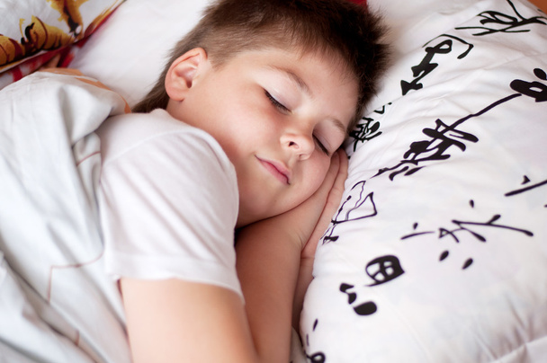 The boy was asleep on a pillow with Chinese characters - Foto, imagen