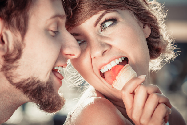 young couple eating ice cream outdoor - Фото, зображення
