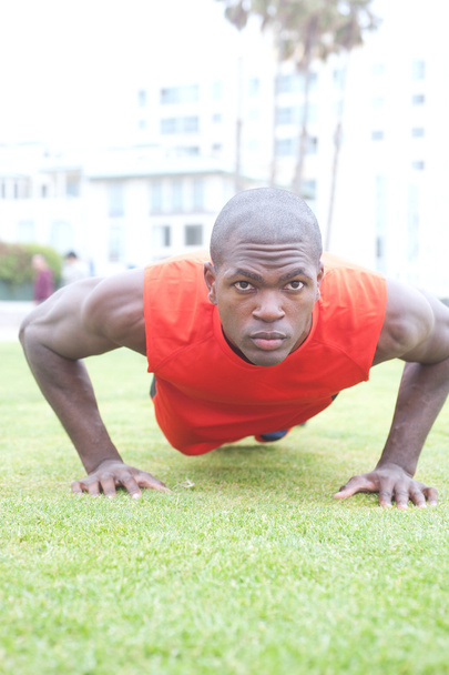 Portrait of an African American athlete doing pushups - Photo, image