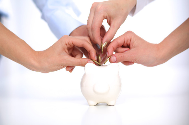 People putting coin into the piggy bank - Photo, Image