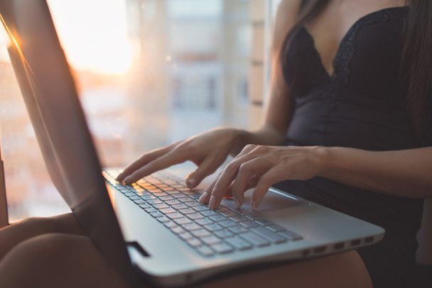 woman sitting at home using laptop - Photo, Image