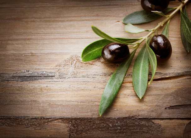 Olives over Wood Background - Фото, изображение