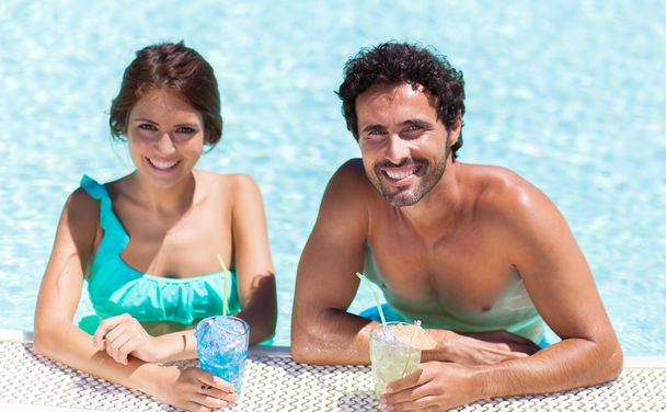 couple having cocktails in pool - Photo, image
