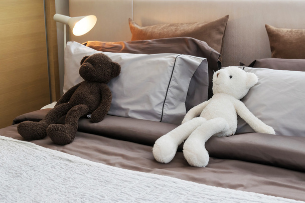kids room with dolls and pillows on bed at home  - Foto, Bild