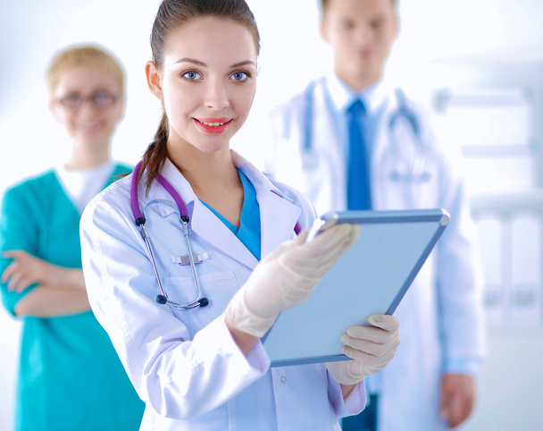 Woman doctor standing with folder at hospital - Photo, image
